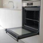 Spotless oven with the door open in an empty Perth rental kitchen ready for the vacate inspection